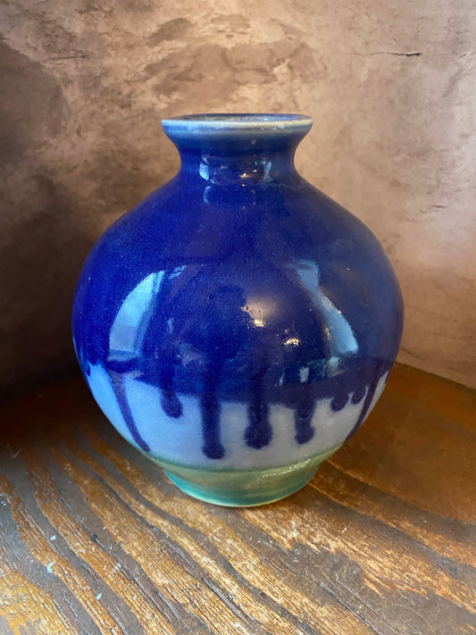 Hand throw pottery vase with cobalt blue glaze dripping over light blue and green glazes.