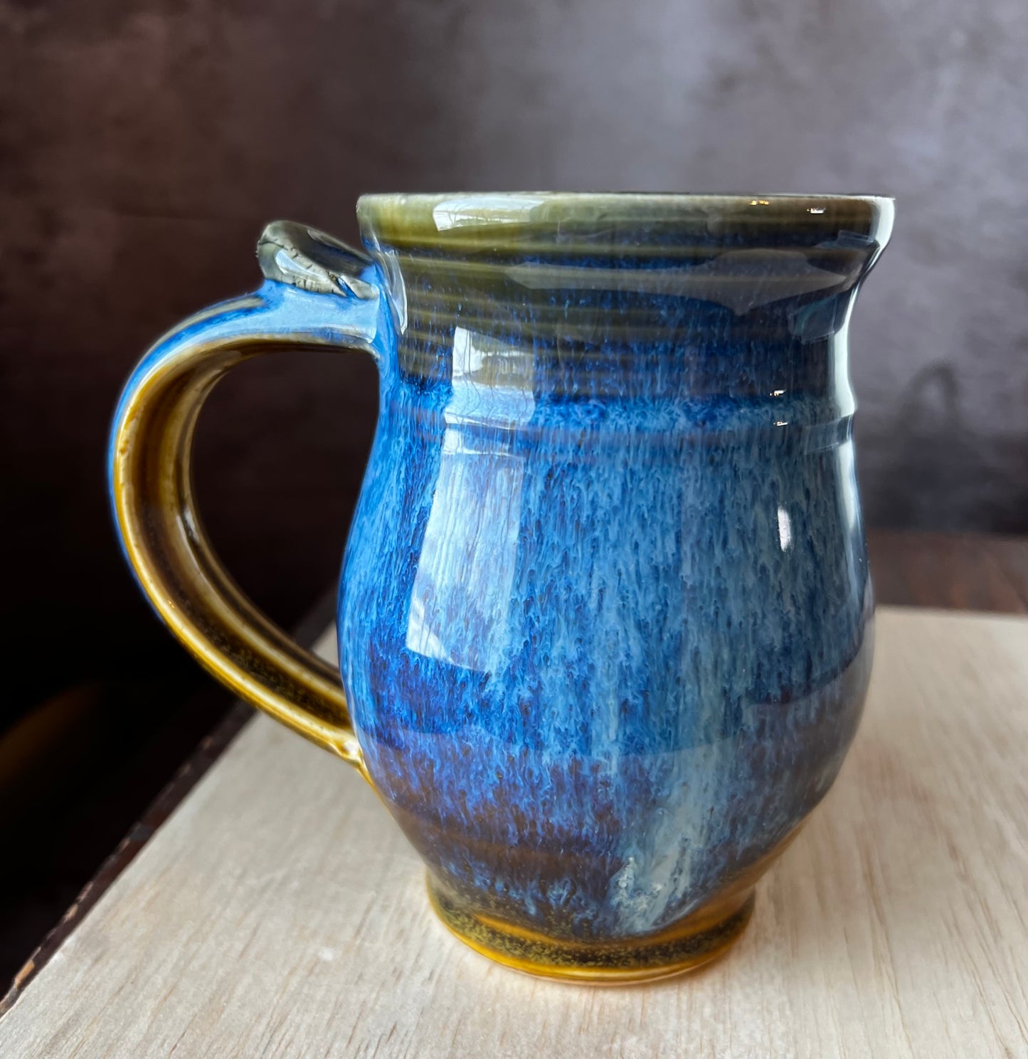 Left handed ceramic mug with blue and brown glaze.