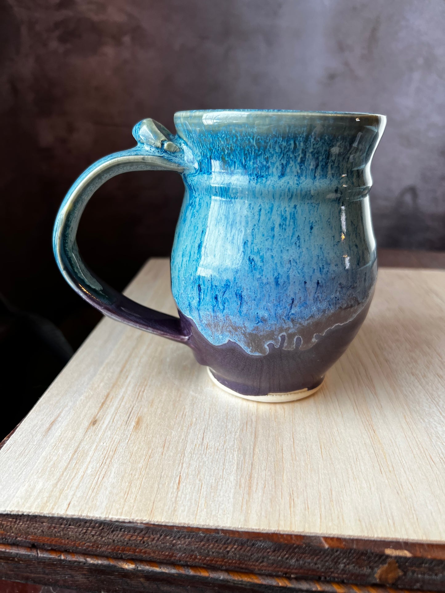 Back side of Moon Goddess ceramic mug showing blue and purple glaze