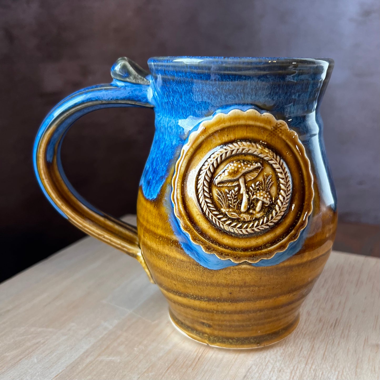 Ceramic mug with mushroom medallion for your foraging fun.