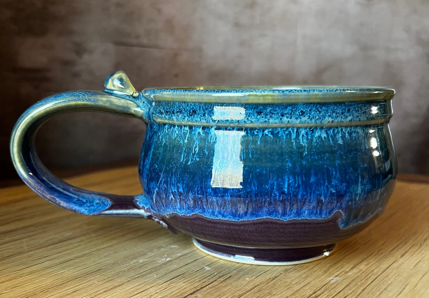 Ceramic soup mug with handle in purple, blue and green.