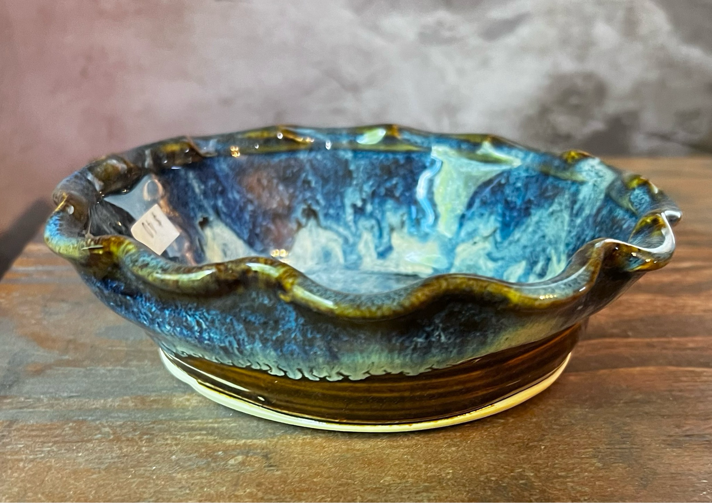 Oven safe tart dish for baking brie, made with stoneware and glazed in blues and browns.