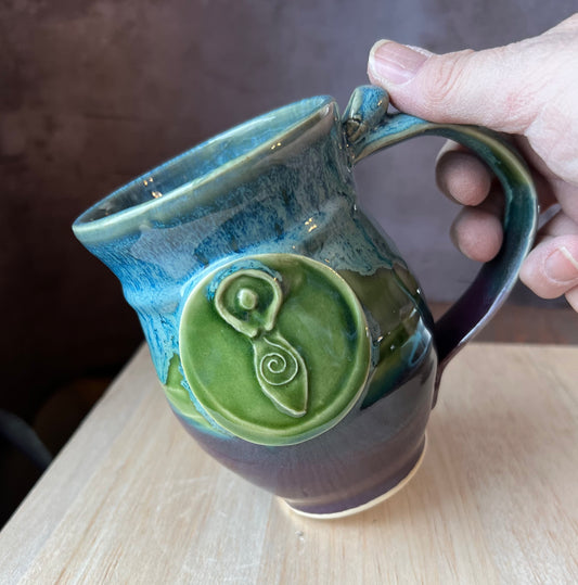 Blue purple and green mug with a Moon Goddess medallion designed for left handed people.