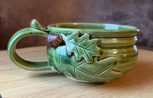 Green and brown glazed soup bowl with a handle. Hand thrown pottery.