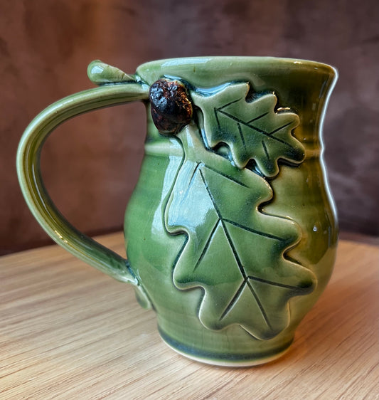 Green and brown glazed round belly tea mug.