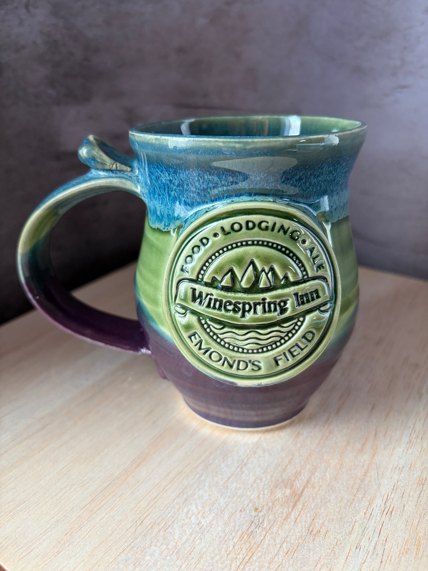 Ceramic mug inspired by Jordan's Wheel of time book series. Including Winespring in and Emond's Field medallion