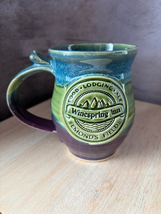 Ceramic mug inspired by Jordan's Wheel of time book series. Including Winespring in and Emond's Field medallion