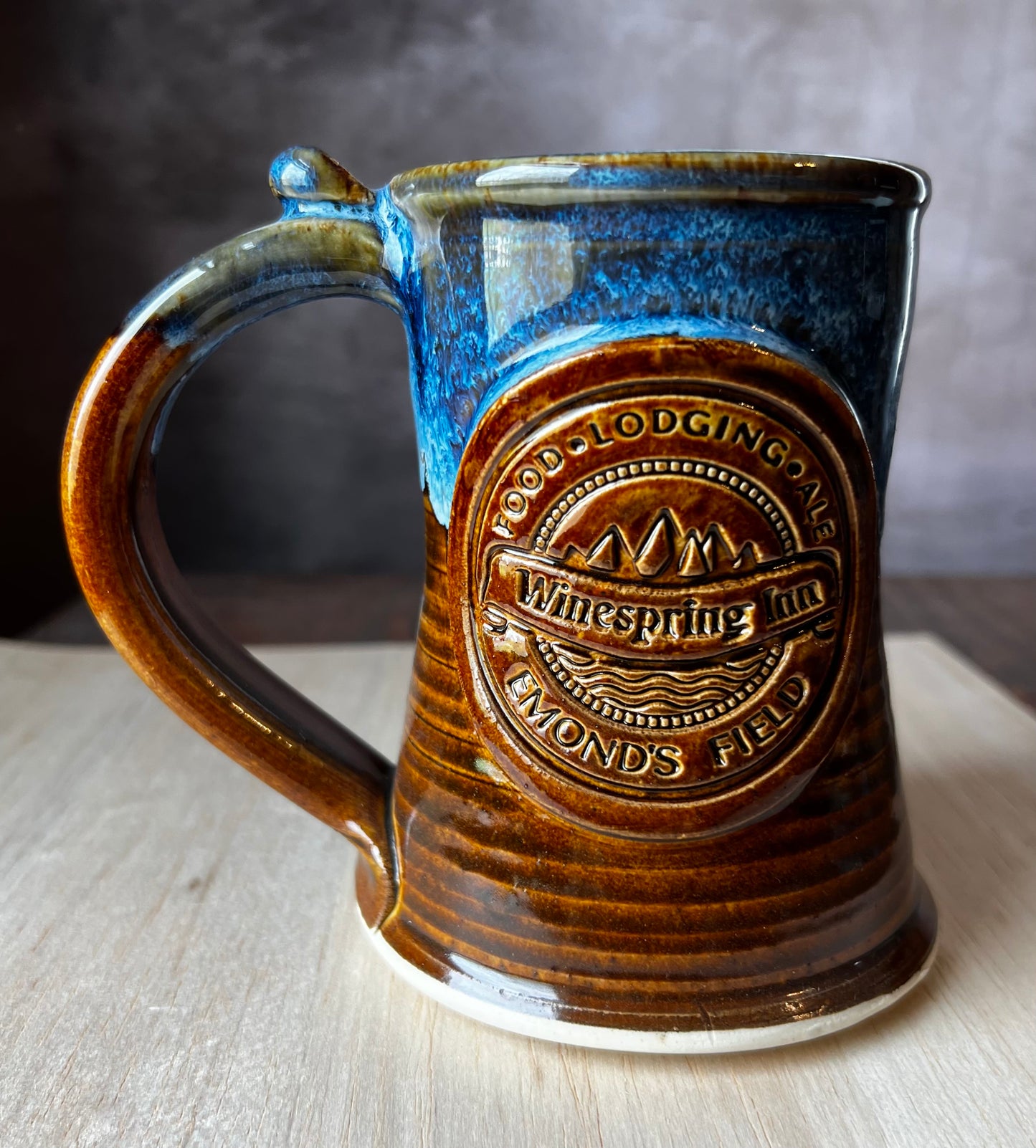 Hand thrown pottery tankard inspired by Jordan's Wheel of Time Series. The medallion includes Winespring Inn