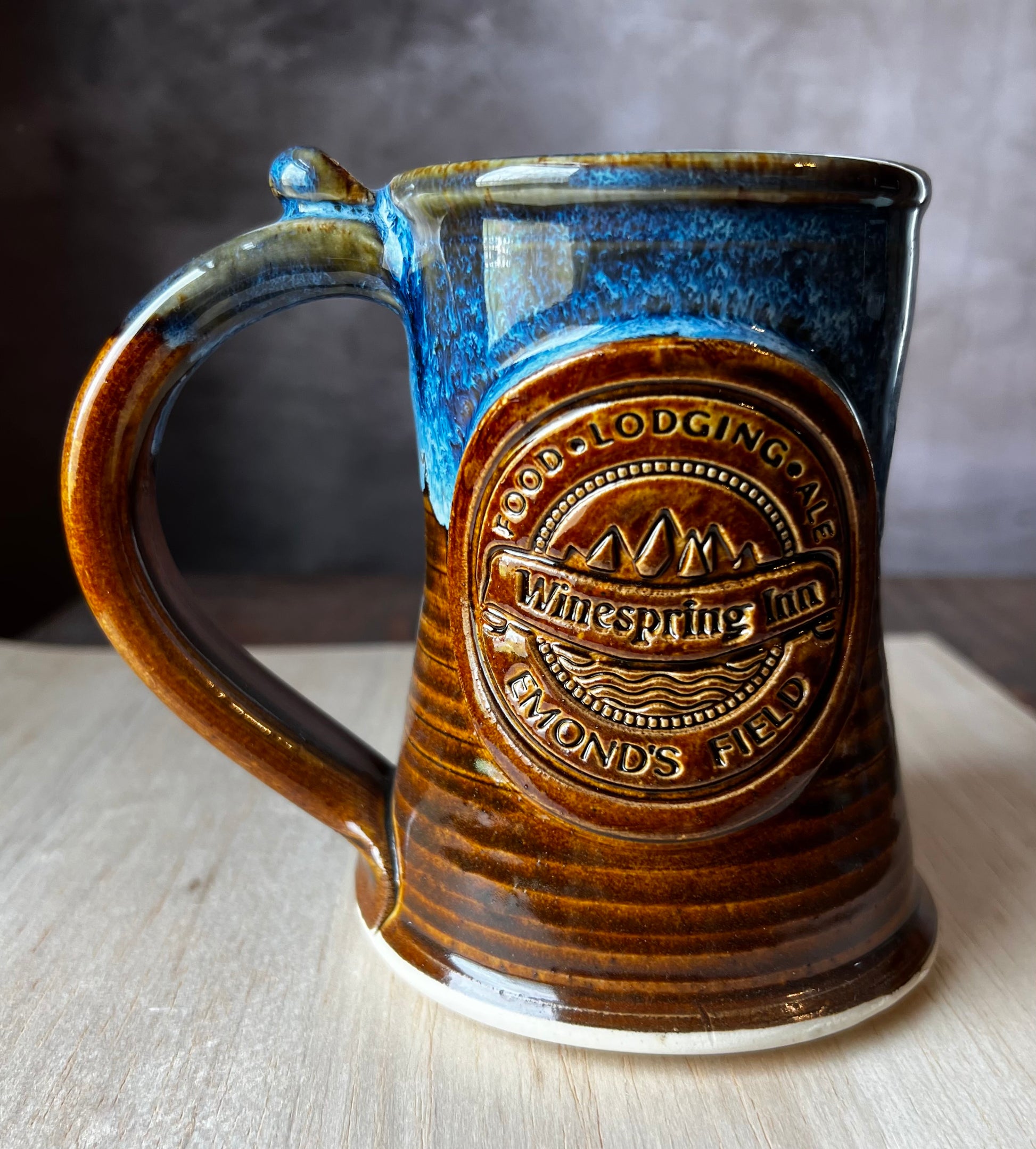 Hand thrown pottery tankard inspired by Jordan's Wheel of Time Series. The medallion includes Winespring Inn